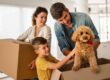 happy family moving with boxes in a new house