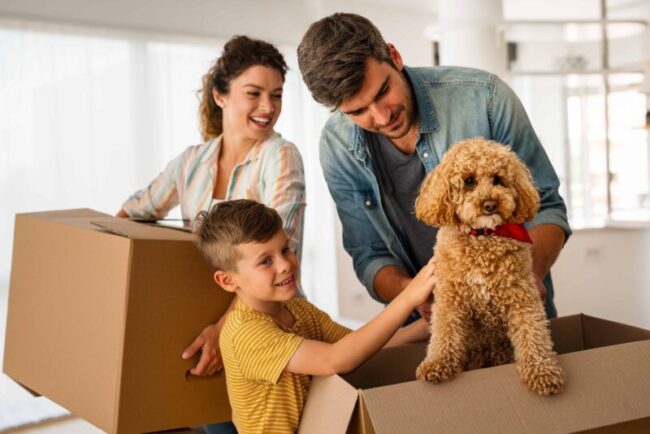happy family moving with boxes in a new house